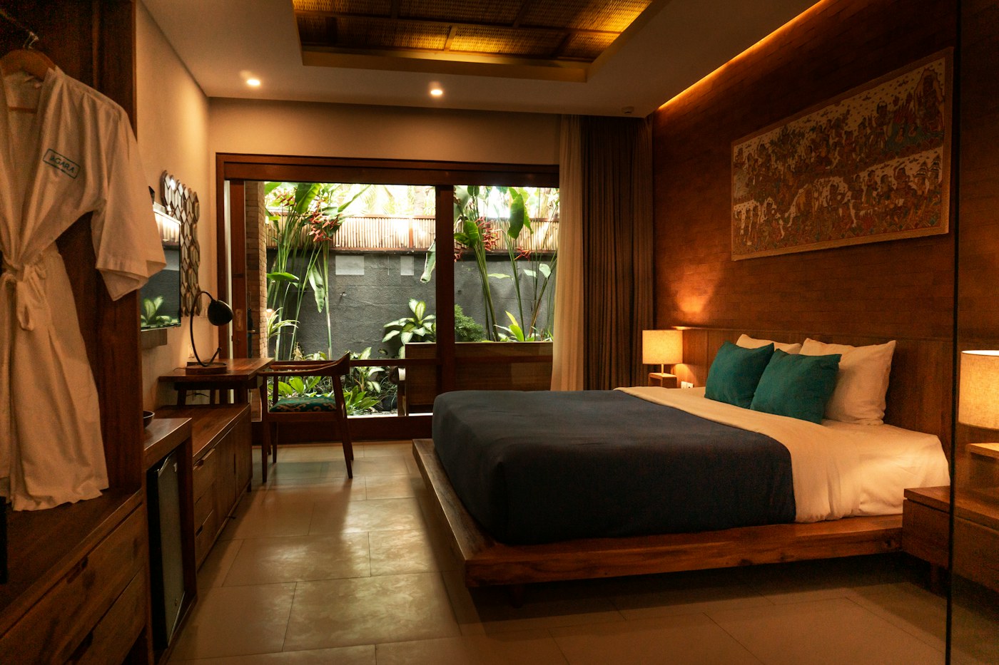 A warmly lit bedroom opening onto a garden